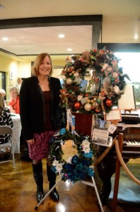 Local author Laura Kepner poses near her wreath (bottom). Credit: Janet Hooper