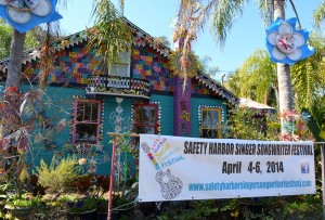 A sign advertising the festival sits in the yard of Whimzeyland.