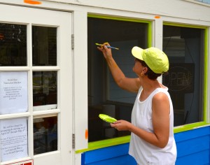 Local artist Stacy Roth works on the new paint scheme for the Harborita Cantina.