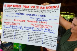 Safety Harbor Reunion organizer Valerie Nolte shows a sign listing all of the event's sponsors.