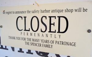 This sign hangs on the wall of Lois Spencer's antique shop.