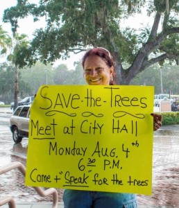 Luara Dent holding her "save the trees" sign on Bayshore Boulevard recently. Credit: Dave Hutchinson