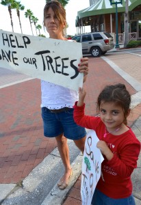 Patricia Capello and her daughter, Sophia, protest the tree removal at the spa.