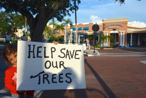 Six-year-old Sophia Capello holds a 'save the trees' sign outside the Safety Harbor Spa on Thursday.