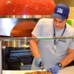 An employee prepares a pizza at the Whole Foods Clearwater store.