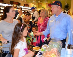 Florida Candy Factory president Scott Rehm talks about his products with patrons at the Whole Foods grand opening.