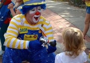 Young Meyah Smith has fun with a clown at the Safety Harbor holiday parade.