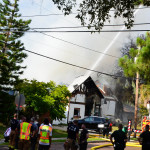 Fire engines pour water on the fire at 233 3rd St. S. on Tuesday.