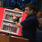 Steve Chickos shows pictures of sign code violations to the Safety Harbor City Commission.