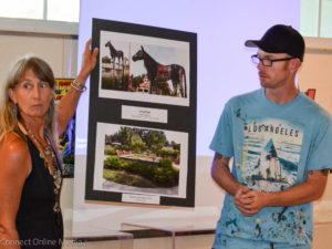 Artists Heather Richardson and Derek Donelly display one of the public art proposals on Monday night.