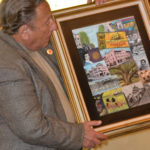 Artist Stu Dwork presents his Safety Harbor centennial themed painting on Monday night.