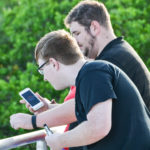 A group of Pokemon GO players search for the electronic creatures at the Safety Harbor Marina on Monday evening.