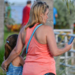 A mother and daughter play Pokemon GO at the Safety Harbor marina on Monday.