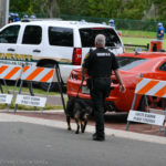 Secret Service agents with trained canines search the area around the Community Center prior to Bill Clinton's speech.