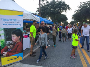 Isabella Diaz hands out bracelets to passersby during Third Friday while raising awareness for the Justin Smelski Foudation for Amoeba Awareness.