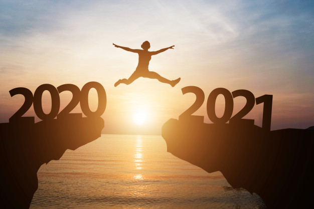 man-jumps-from-year-2020-2021-with-sunlight-sea-as ...